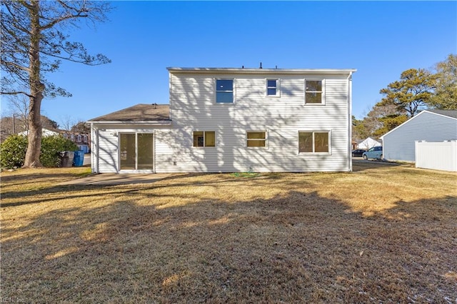 back of property featuring a yard and a patio