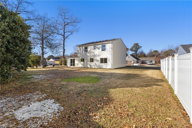 back of property featuring a lawn