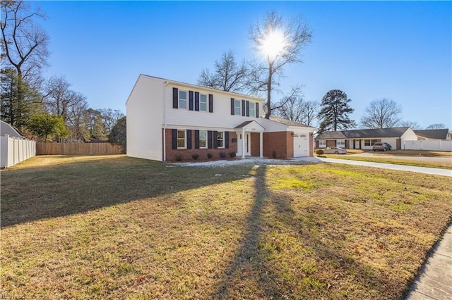 view of front of property with a front yard and a garage