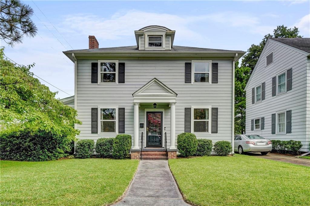 colonial inspired home with a front lawn