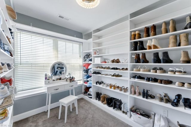 spacious closet featuring light carpet