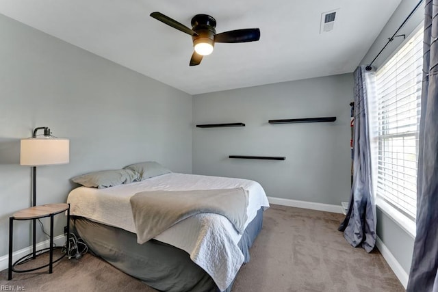 bedroom featuring ceiling fan and light carpet