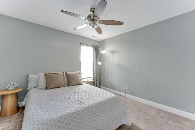 bedroom featuring ceiling fan and carpet