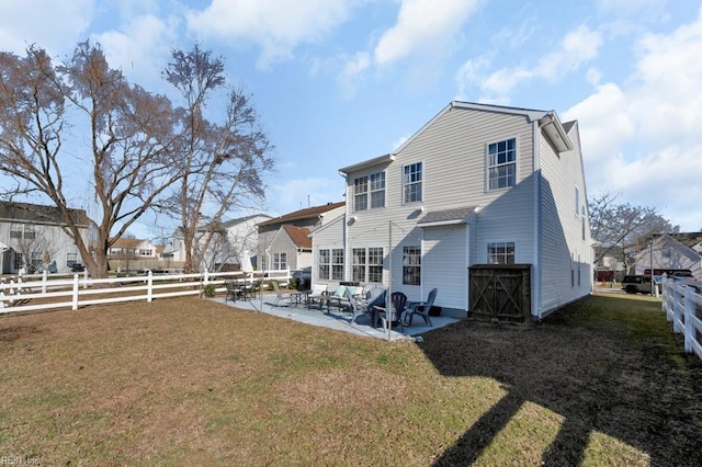 rear view of property with a patio area and a yard