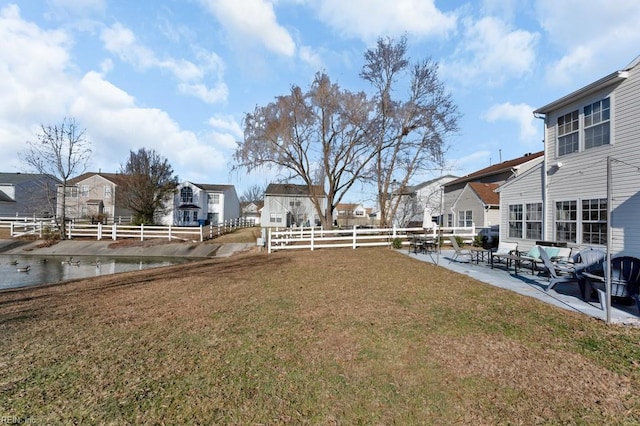 view of yard featuring a water view and a patio