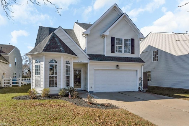 view of property with a front lawn and a garage