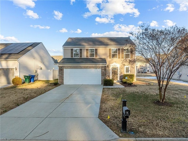 view of front of home featuring a front yard and a garage