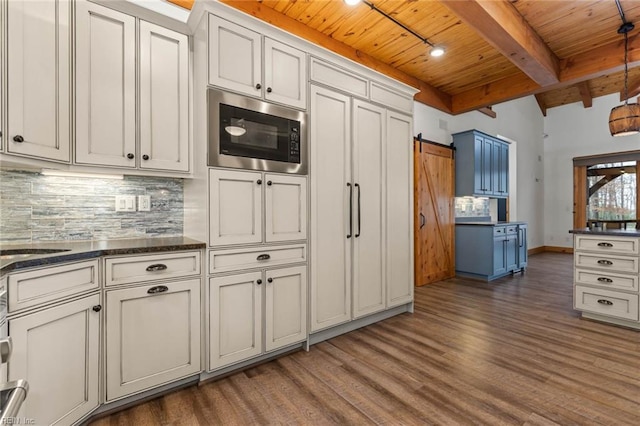 kitchen featuring white cabinets, wooden ceiling, beam ceiling, a barn door, and built in microwave