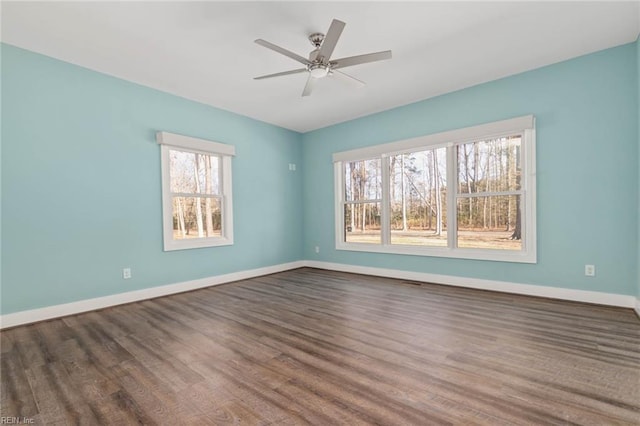 empty room featuring ceiling fan and dark hardwood / wood-style flooring