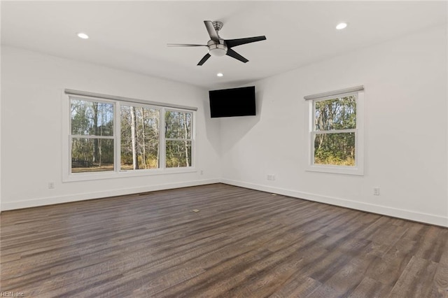 unfurnished living room with ceiling fan, a healthy amount of sunlight, and dark hardwood / wood-style floors