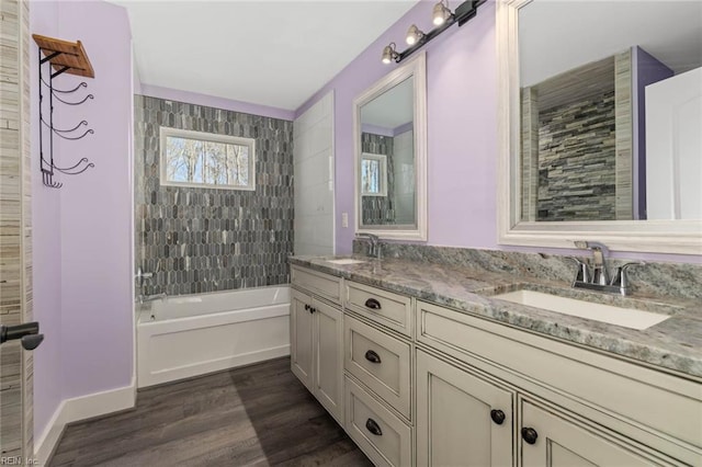 bathroom with tiled shower / bath, vanity, and hardwood / wood-style flooring