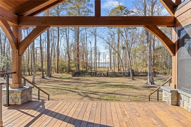 wooden deck featuring a lawn