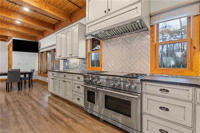 kitchen featuring wood ceiling, range with two ovens, beamed ceiling, decorative backsplash, and custom range hood