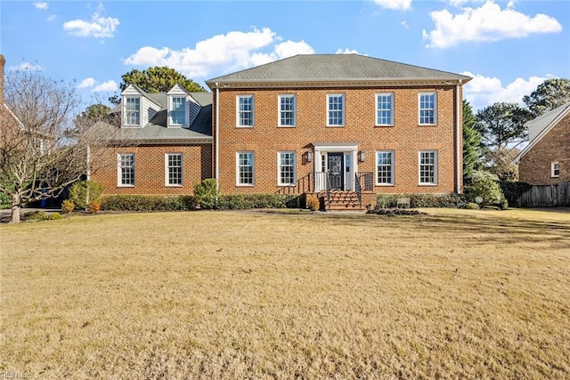 colonial home with a front lawn