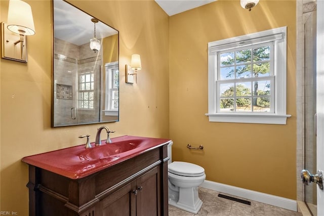 bathroom with toilet, vanity, and tile patterned floors