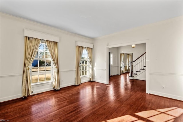 empty room featuring ornamental molding and dark hardwood / wood-style floors