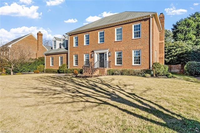 colonial home featuring a front yard