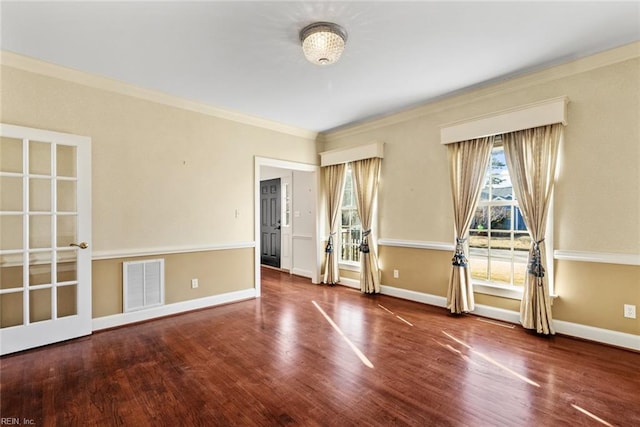 empty room with wood-type flooring and ornamental molding