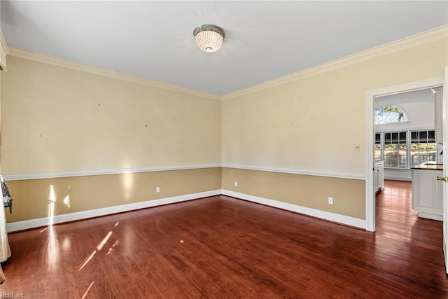 spare room featuring ornamental molding and dark hardwood / wood-style floors