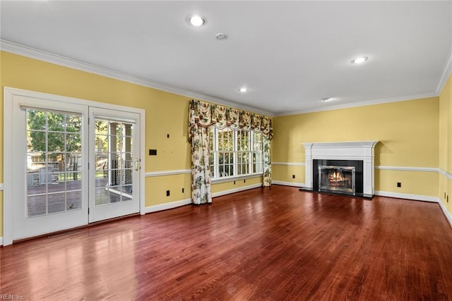 unfurnished living room with wood-type flooring and crown molding