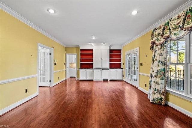 unfurnished living room featuring french doors, dark hardwood / wood-style flooring, and crown molding