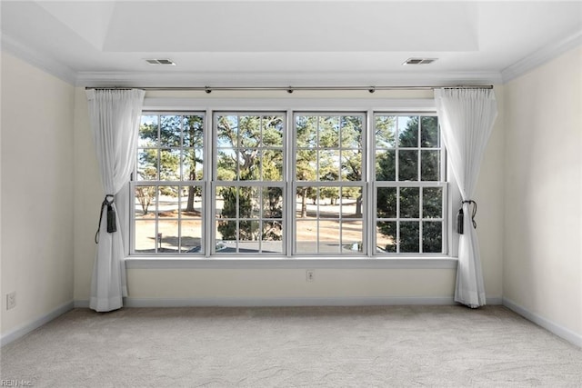 spare room with light carpet, a wealth of natural light, and crown molding