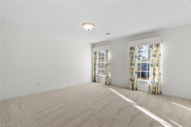 unfurnished room featuring light carpet