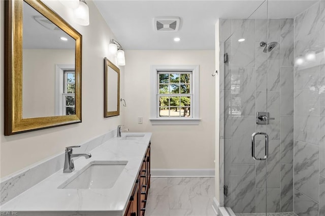 bathroom with vanity and a shower with shower door