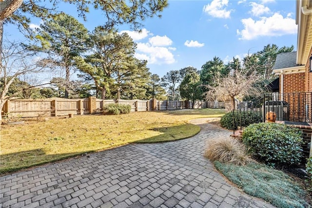 view of community featuring a patio area and a lawn