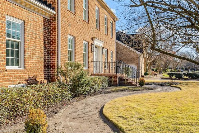 view of side of home with a lawn