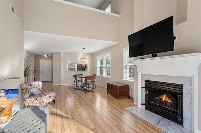 living room with a premium fireplace and light wood-type flooring