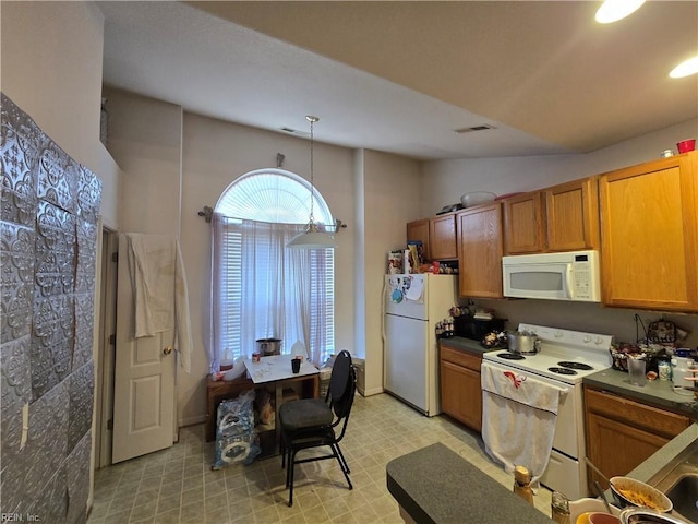 kitchen with decorative light fixtures and white appliances