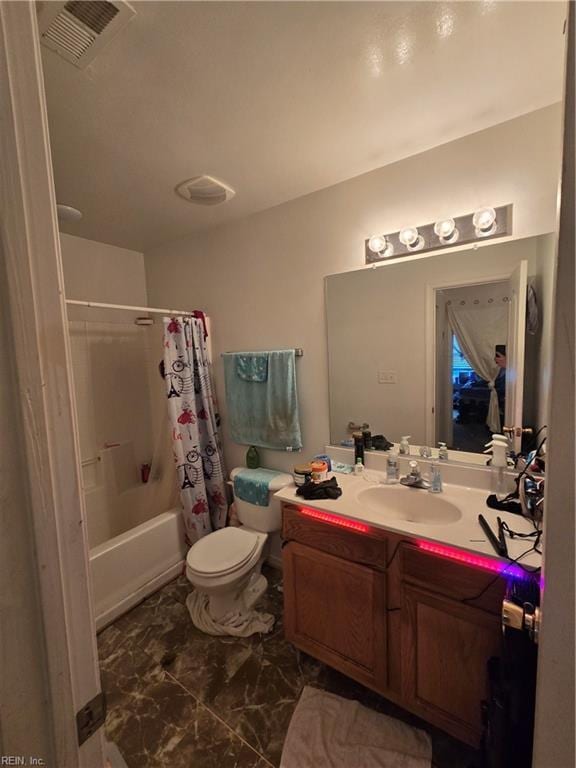 full bathroom featuring toilet, vanity, and shower / bathtub combination with curtain