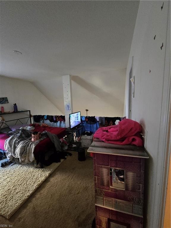 bedroom featuring lofted ceiling and carpet floors