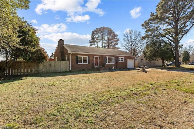 ranch-style house featuring a front yard and a garage