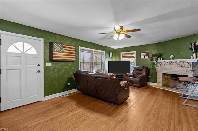 living room featuring ceiling fan and hardwood / wood-style floors