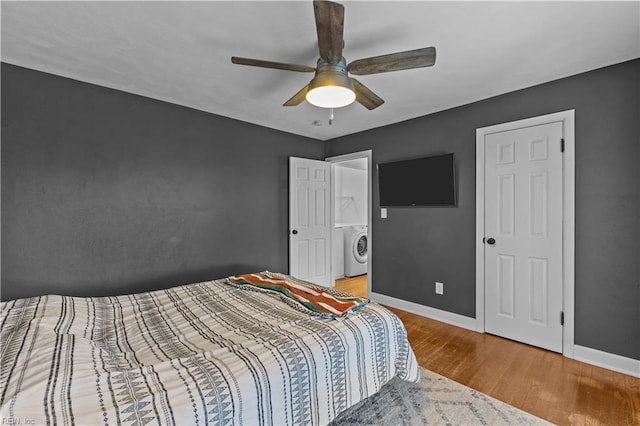 bedroom with washer / dryer, ceiling fan, and hardwood / wood-style floors