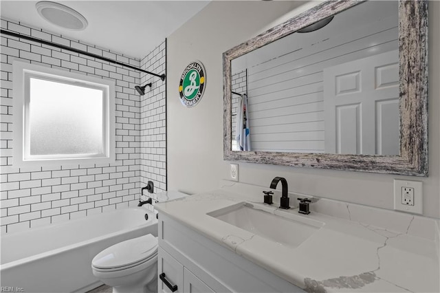 full bathroom with tiled shower / bath combo, vanity, and toilet