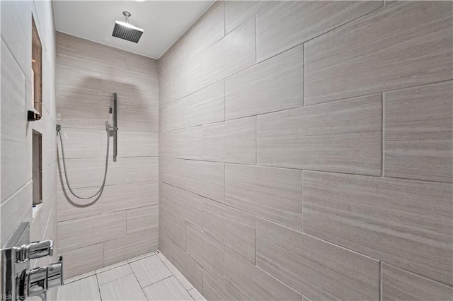 bathroom with a tile shower