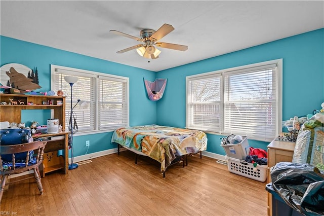 bedroom with ceiling fan and light hardwood / wood-style flooring