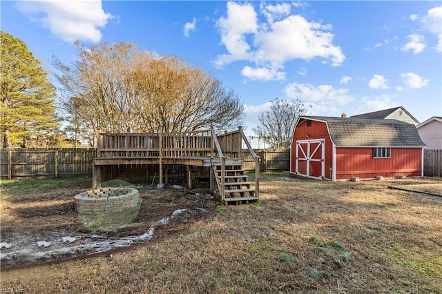 view of yard with a fire pit, a wooden deck, and a shed