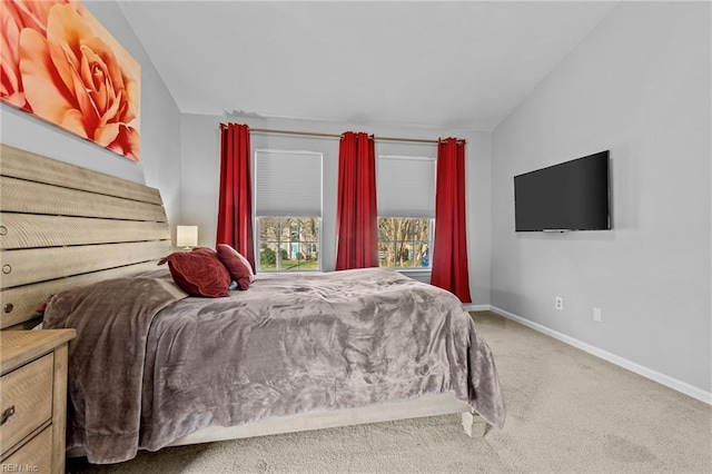 bedroom with lofted ceiling and carpet