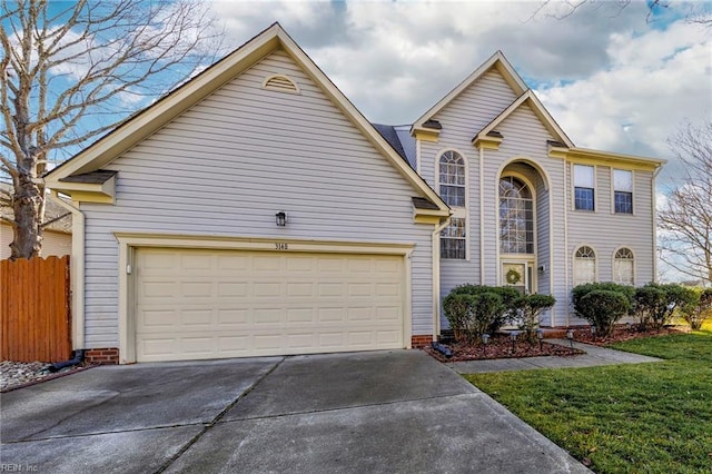 front of property with a garage and a front lawn