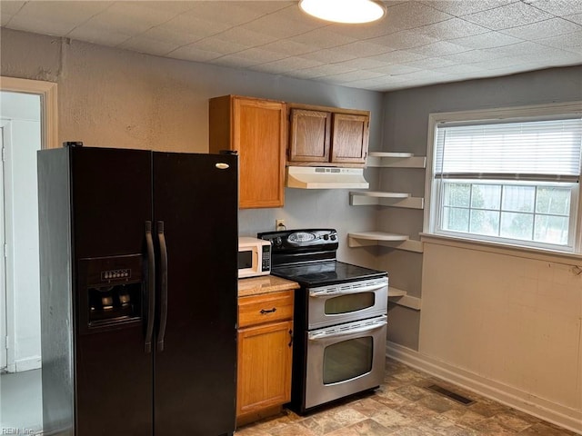 kitchen with black refrigerator with ice dispenser and double oven range