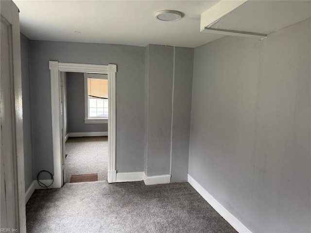 unfurnished room featuring carpet