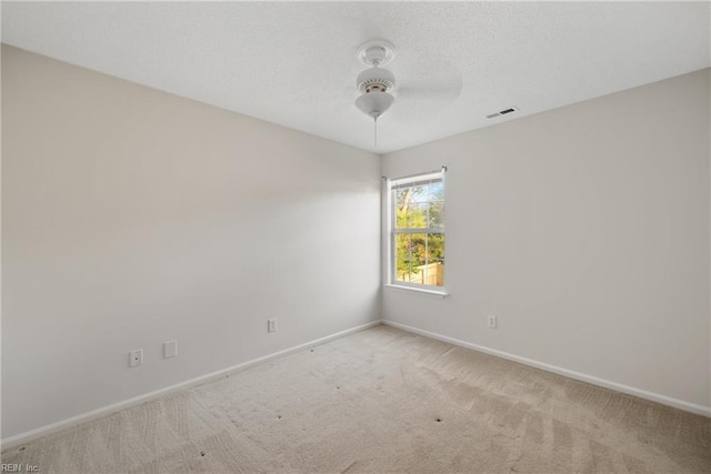 unfurnished room featuring ceiling fan and light colored carpet