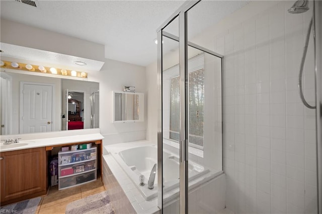 bathroom with vanity, independent shower and bath, and tile patterned flooring