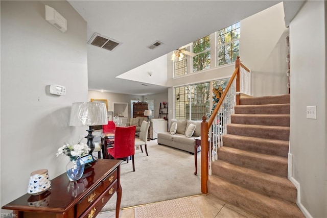 living room with carpet floors and a high ceiling