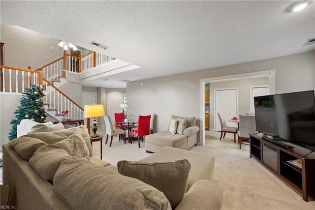 living room with a textured ceiling and light carpet