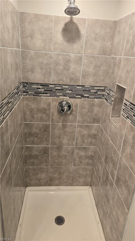 bathroom with tiled shower